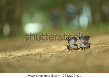 Two cooling glasses are placed one above the other on the ground background blur