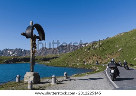 Bikers near lake Bianco at Gavia Pass - Lombardy, Italy Royalty-Free Stock Photo #2312225145