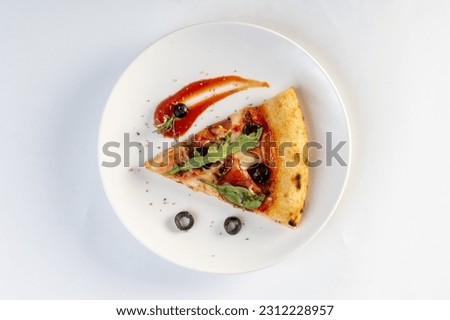 Home made pizza topped with black forest ham, tomatoes, spices, black olives, on white background