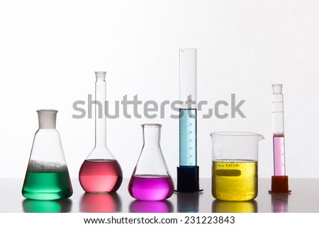 Glass in a chemical laboratory filled with colored liquid during the reaction