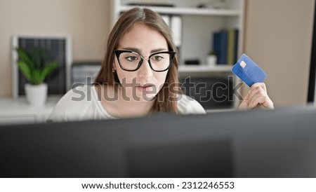 Young beautiful hispanic woman business worker using computer and credit card at office