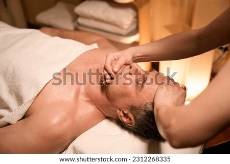 Osteopathic physician performing cervical spine mobilization on patient