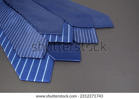 various pattern's neckties layered together with dark floor, close up shot of neckties patterns  Royalty-Free Stock Photo #2312271743