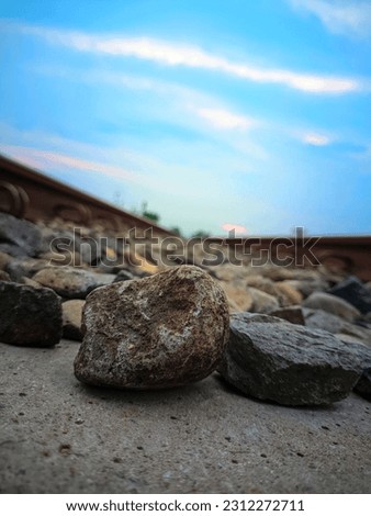 rock in the middle of the train tracks