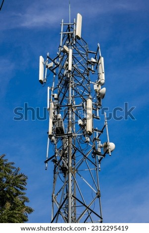 top of a cell tower against a blue sky, Detail shot of telecommunication tower for smartphone and wireless internet provider.  Royalty-Free Stock Photo #2312295419