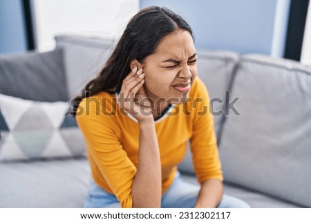 Young african american woman suffering for ear problem at home