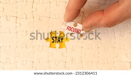 Stay focused symbol. Concept words Stay focused on beautiful white puzzles on beautiful white background. Businessman hand. Business support motivation psychological stay focused concept. Copy space Royalty-Free Stock Photo #2312306411