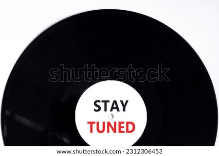 Stay tuned symbol. Concept words Stay tuned on beautiful black vinyl disk on a beautiful white table white background. Business, support, motivation, psychological and stay tuned concept. Copy space.