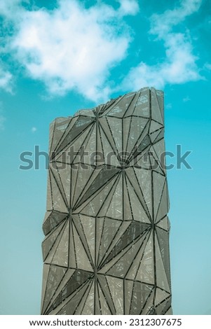 Abstract metal tower, geometric shapes statue structure, artistic cladding