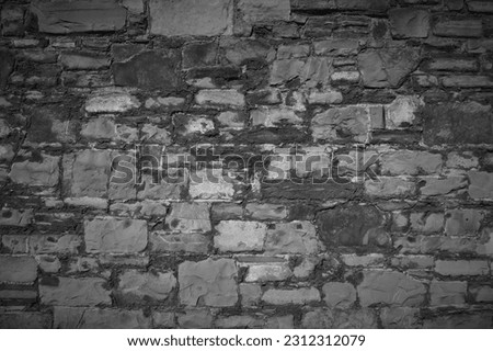 Decorative wall made of natural stones. Black and white background.