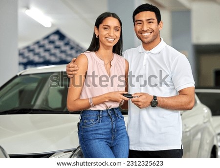 Couple at car dealership, choice and transport with key, people buy new vehicle with luxury and smile in portrait. Happy with decision, man and woman at automobile showroom with purchase and cars Royalty-Free Stock Photo #2312325623