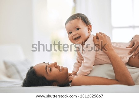 Mom lying, cuddle newborn and bedroom with smile, care and happiness in morning with love, bond or excited face. Young mother, baby and happy in bed, family home or holding kid with pride together Royalty-Free Stock Photo #2312325867