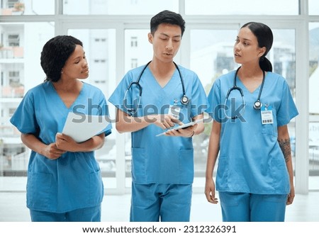 Teamwork, discussion or surgeons with tablet planning strategy in hospital in collaboration meeting. Leadership, doctors or nurses talking or speaking of healthcare research, reports or digital news Royalty-Free Stock Photo #2312326391