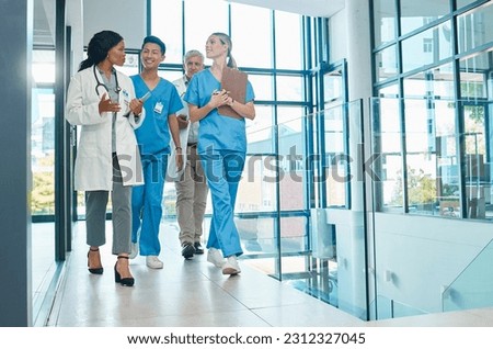 Healthcare, doctors and nurses walking together for discussion, planning or schedule. Diversity, men or women medical group talking about support strategy, medicine and surgery teamwork in hospital Royalty-Free Stock Photo #2312327045