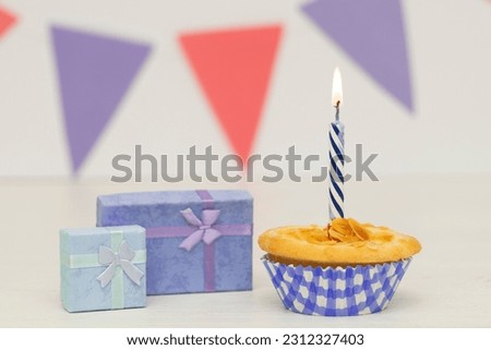 Two birthday gift box with cupcake on wood background