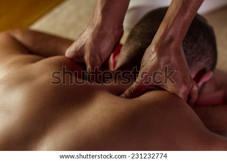 Man has deep tissue massage on the back. Royalty-Free Stock Photo #231232774