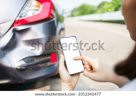 Asian woman got a car accident or car crash and using smartphone to call for road side emergency service. Woman texting on smartphone to call insurance assistant service. Royalty-Free Stock Photo #2312342477