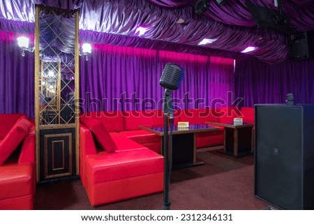 Professional microphone in sound recording studio with purple background, Podcast or recording studio background copy space space for text