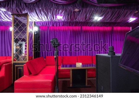 Professional microphone in sound recording studio with purple background, Podcast or recording studio background copy space space for text