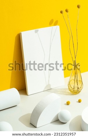 Magazine cover mockup on yellow background with geometric shapes and flowers in vase