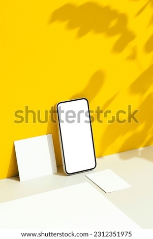 Smartphone and business card , stationary mockup, template on yellow background with floral background