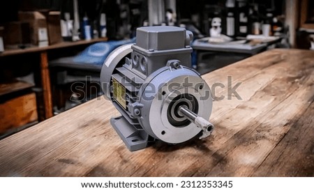 An electromotor on a wooden table with a workshop background  Royalty-Free Stock Photo #2312353345