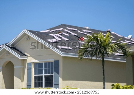 Construction on a new roof being worked on Royalty-Free Stock Photo #2312369755