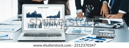Panorama shot analyst team utilizing BI Fintech to analyze financial report with laptop. Businesspeople analyzing BI data dashboard displayed on laptop screen for business insight. Prodigy