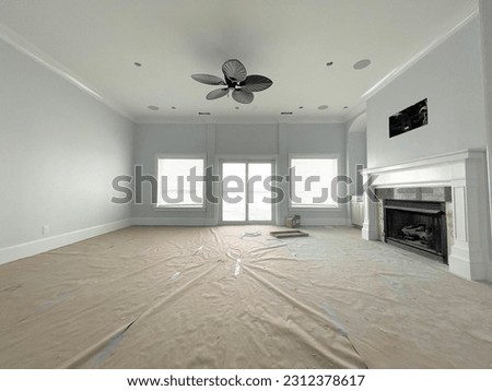 Large, well lit living room space that has been freshly painted with two coats on the ceiling, walls and the trim. The finished produce after paint.
