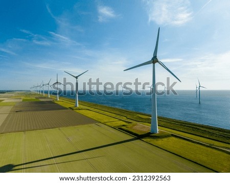 Group Windmills on Land and Sea for Sustainable Energy near Urk, Netherlands Royalty-Free Stock Photo #2312392563