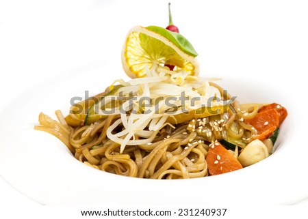 spaghetti with chicken and vegetables on a white background in the restaurant