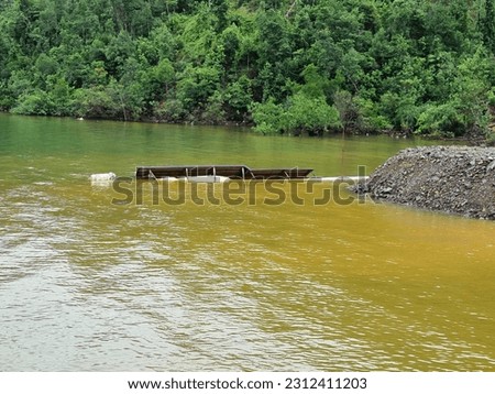 sunk ship in shallow waters Royalty-Free Stock Photo #2312411203