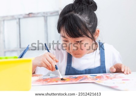 Girl drawing a picture in class