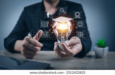 E-learning online graduate course concept online male hand holding light bulb display graduation cap icon internet for knowledge ideas start with global creative experience Royalty-Free Stock Photo #2312432833