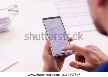 Taking Receipt Document Photo Using Phone Or Smartphone Royalty-Free Stock Photo #2312447567