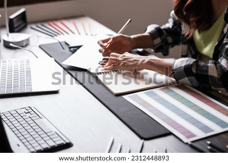 Graphic designer working with sketching logo design at office Royalty-Free Stock Photo #2312448893