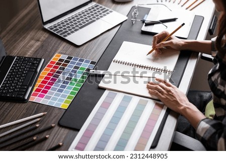 Graphic designer working with sketching logo design at office Royalty-Free Stock Photo #2312448905
