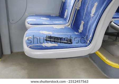 forget smartphone on public bus sit  Royalty-Free Stock Photo #2312457563