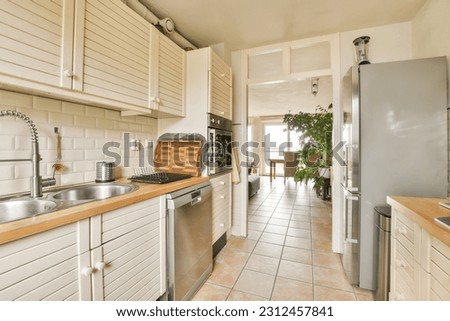 a kitchen with all white cabinets and appliances on the counter top in front of the sink is an open door