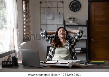 Asian graphic designer resting her eyes during work