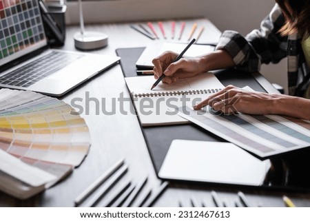 Graphic designer working with sketching logo design at office