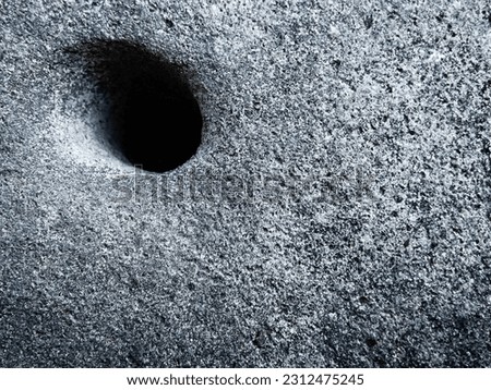 Semarang, Central Java, Indonesia 2023, dark gray decorative natural stone with hole as object, photographed early in the morning in Semarang, Central Java, Indonesia 2023