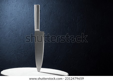 A professional kitchen knife, a knife stuck in wood. Close-up of a professional kitchen knife. Background with copy space