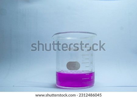beaker glass 500ml fill by purple liquid base solution isolated in white is chemistry laboratory glassware