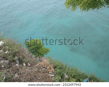 The beautiful view from the top of the cliff sees turquoise sea water