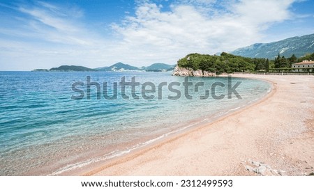 Waves gently lap against Milocer Beach on the Montenegro coastline under a blue sky pictured in May 2023.