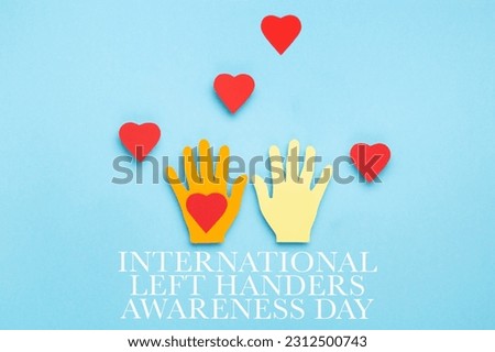 International Left Handers Day Concept, 13th august. Colorful paper left hand and red hearts on blue background, copy space, top view. Royalty-Free Stock Photo #2312500743