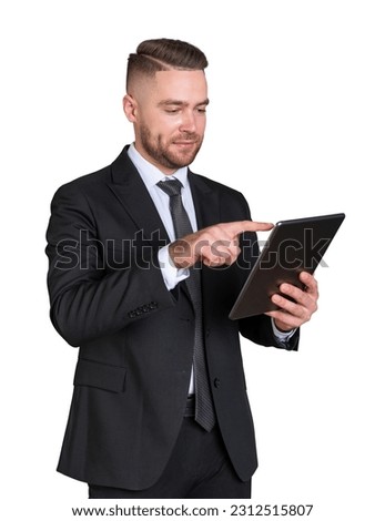 Portrait of bearded young European businessman in suit using tablet computer isolated on white background. Concept of social media and business communication