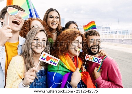 Happy group of young people celebrating gay pride day festival together. Millennial homosexual adult friends enjoying celebration about equal rights and freedom Royalty-Free Stock Photo #2312542395