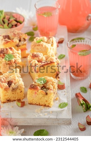 Sweet and sour rhubarb yeast cake as traditional summer cake. Rhubarb butter cake and compote.